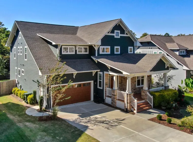 Craftsman-style family home with a covered front porch and a two-car garage